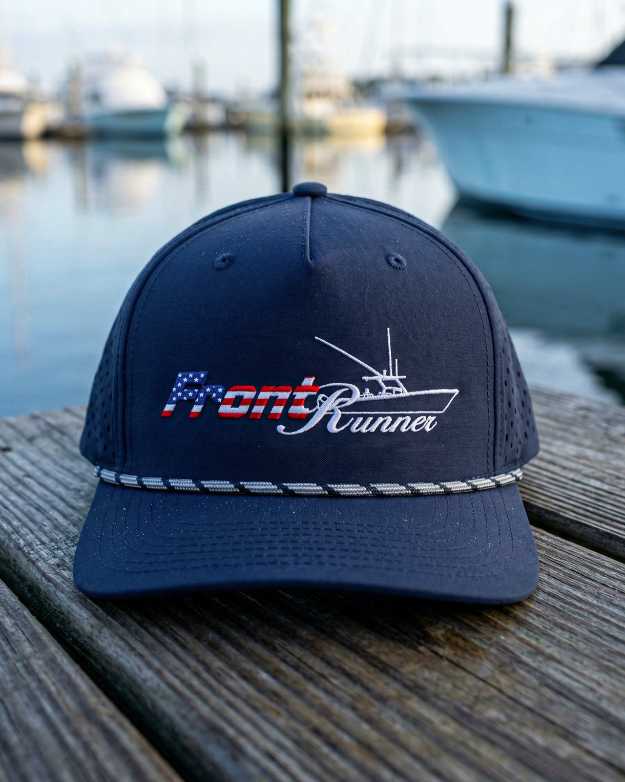 Finished navy cap with boat artwork on the dock