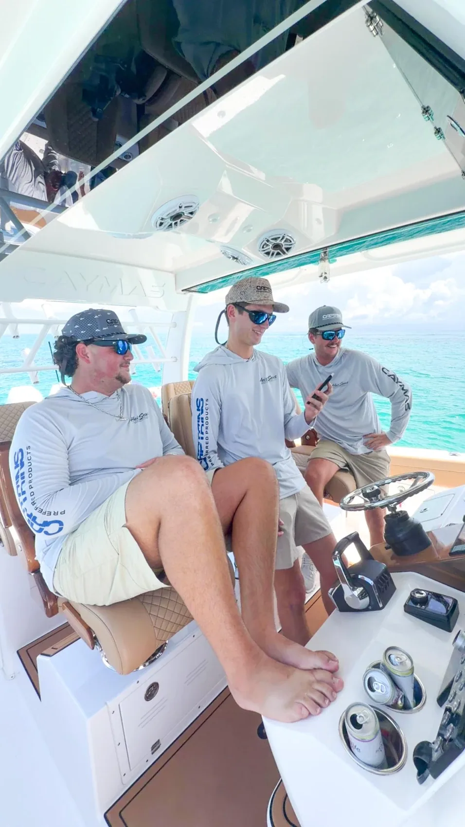 Actual crew wearing printed performance shirts at the helm